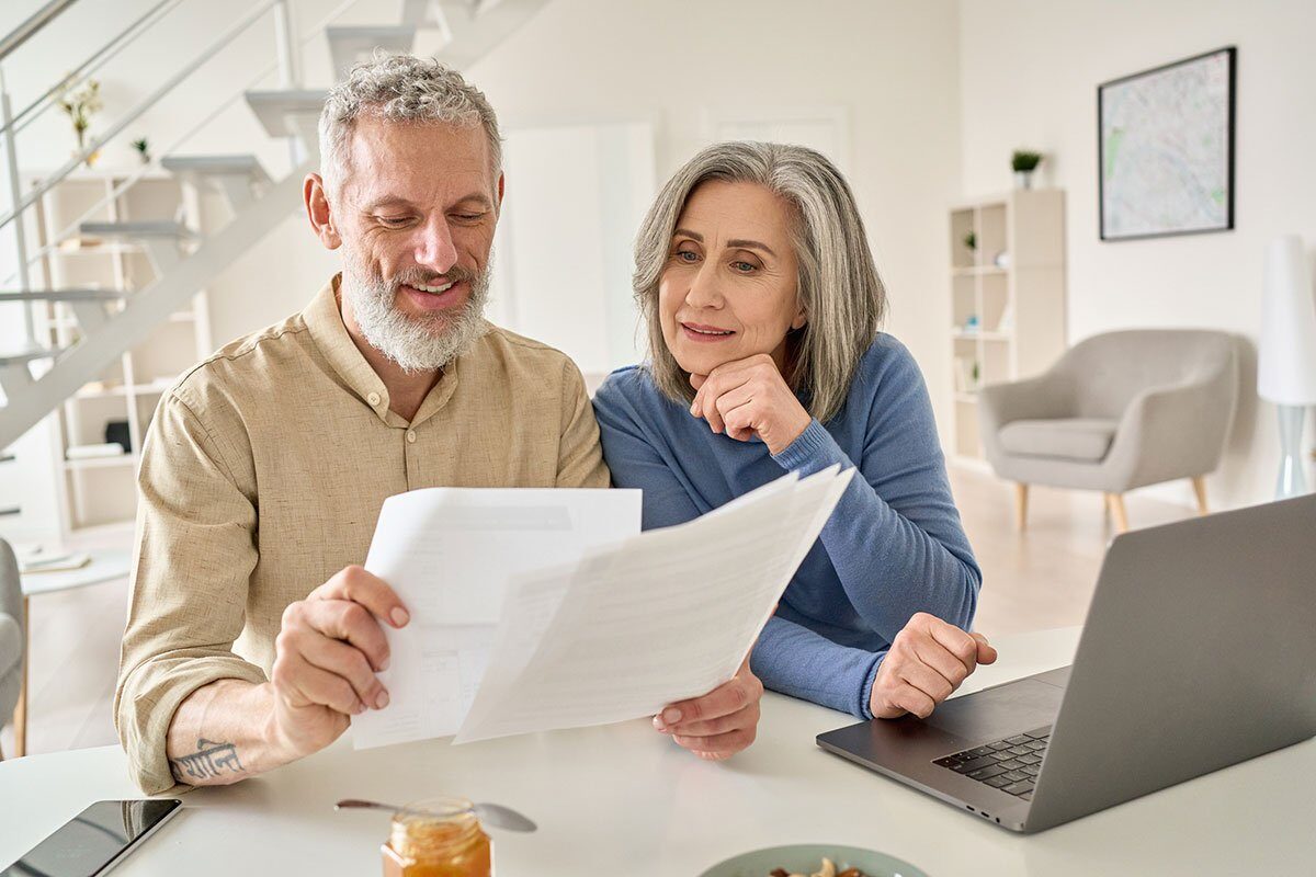 Middle aged couple doing retirement planning at home.