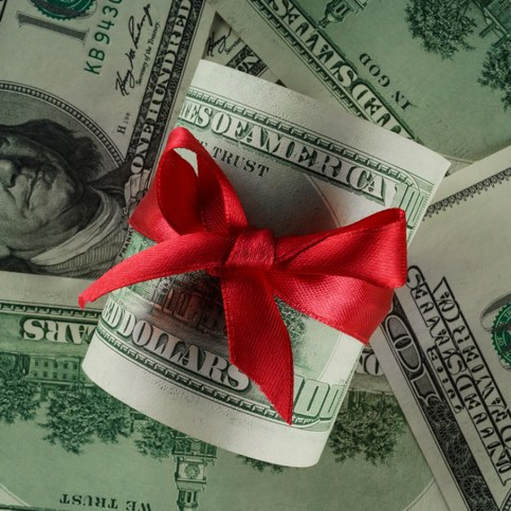 Close up concept image of money with red ribbon