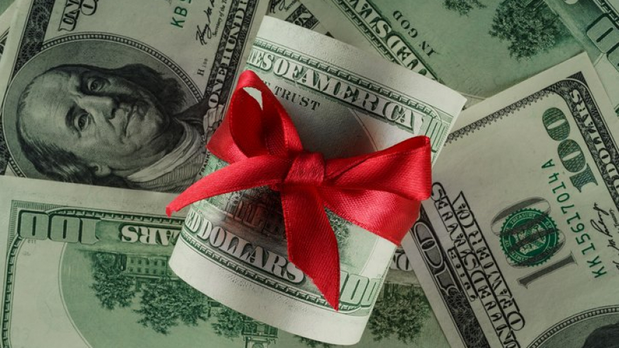 Close up concept image of money with red ribbon
