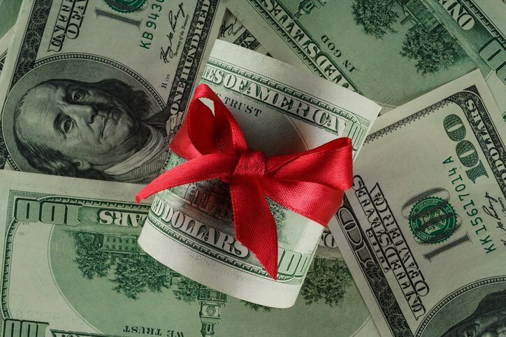 Close up concept image of money with red ribbon