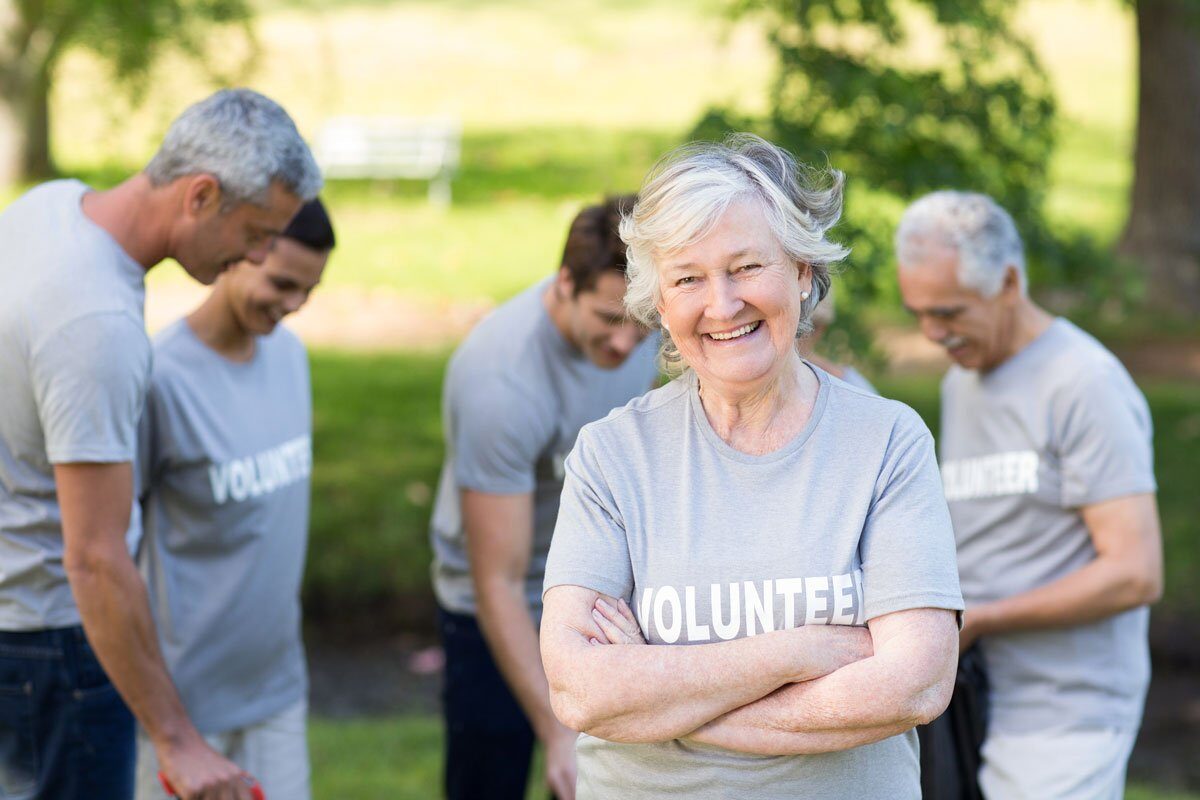 Happy senior volunteer smiling at camera