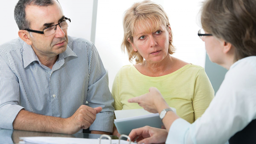 Couple speaking with their Estate Planning attorney about setting up a revocable living trust