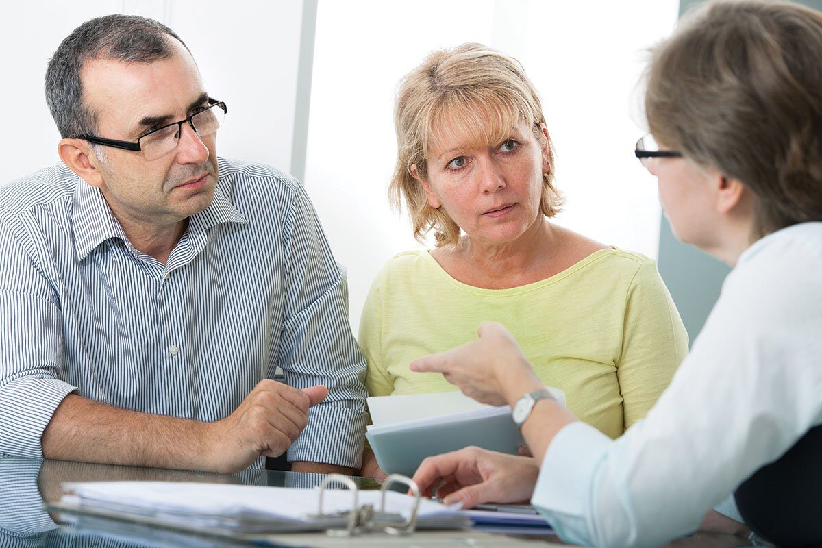 Couple speaking with their Estate Planning attorney about setting up a revocable living trust