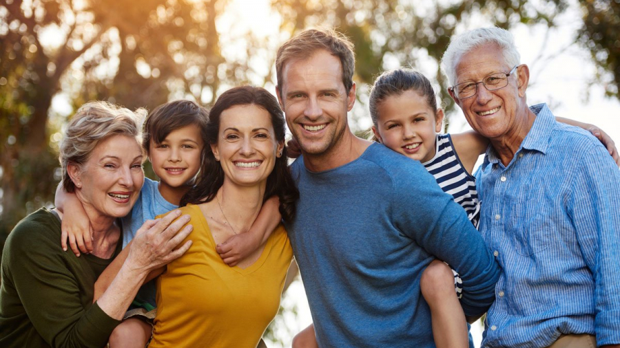 Portrait of a family with two young children posing together outside