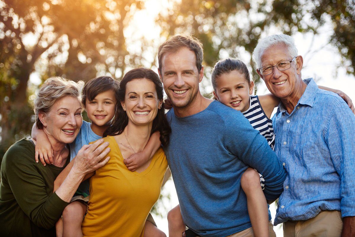 Portrait of a family with two young children posing together outside