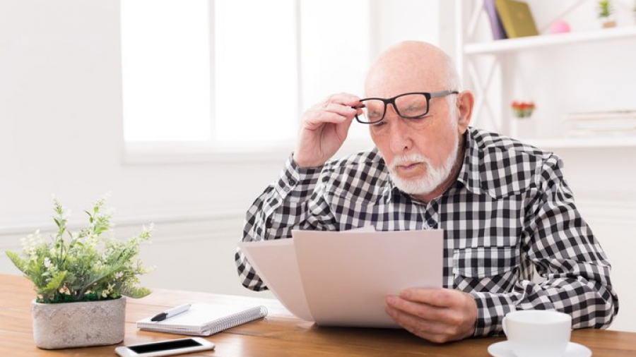 Senior man looking at Medicaid documents