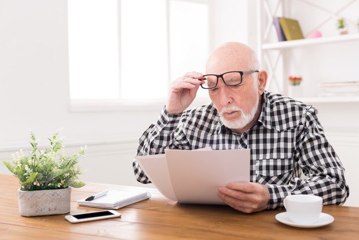 Senior man looking at Medicaid documents