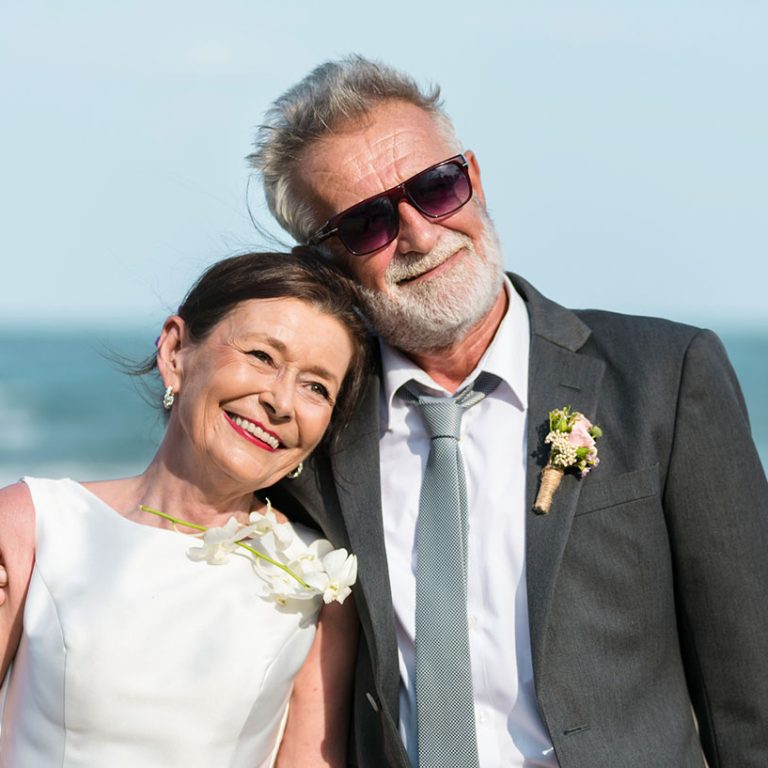 Senior couple getting married at the beach