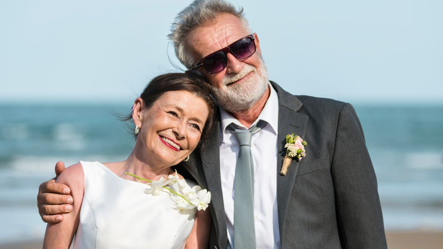 Senior couple getting married at the beach