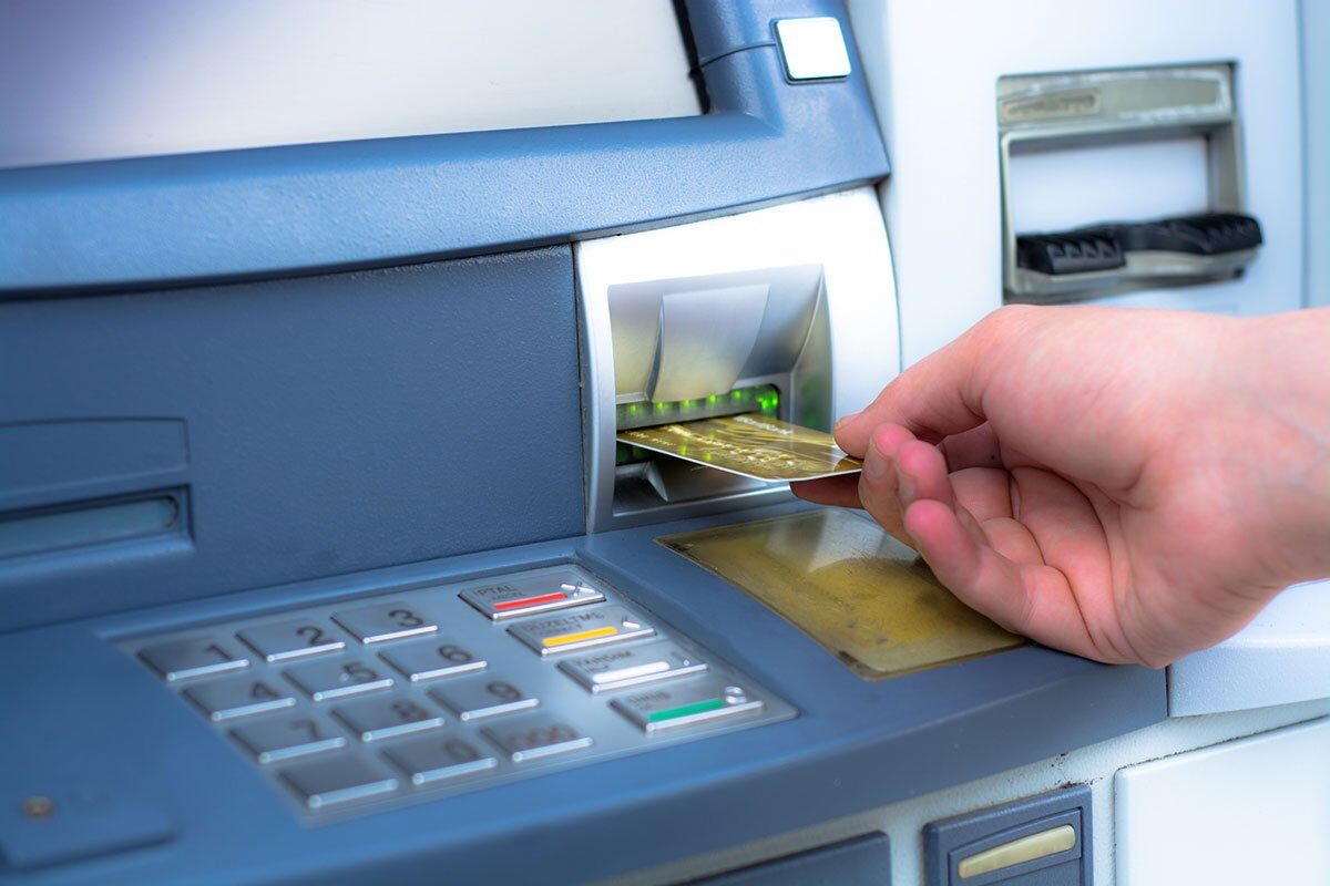 ATM skimming. Hand inserting ATM credit card