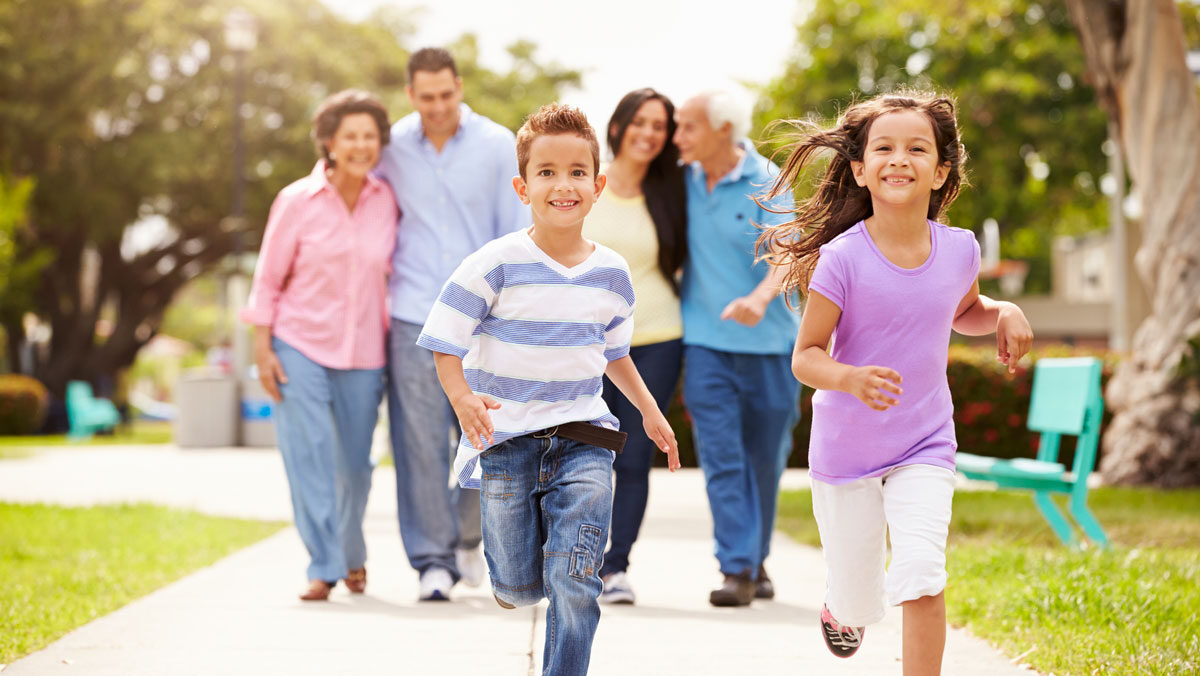 mult-generational family taking a walk through park